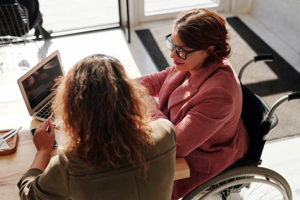 Business woman in wheelchair running a meeting