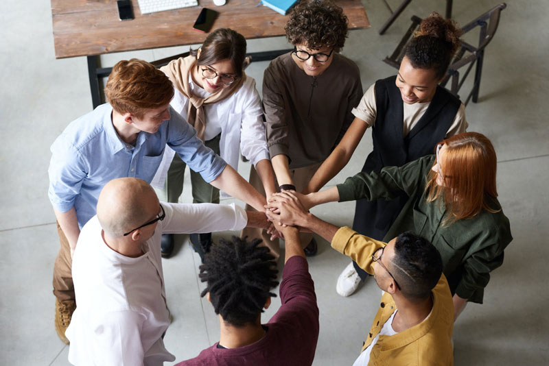 Support group with hands in the center of circle