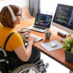 Woman in wheel chair performing work on a computer