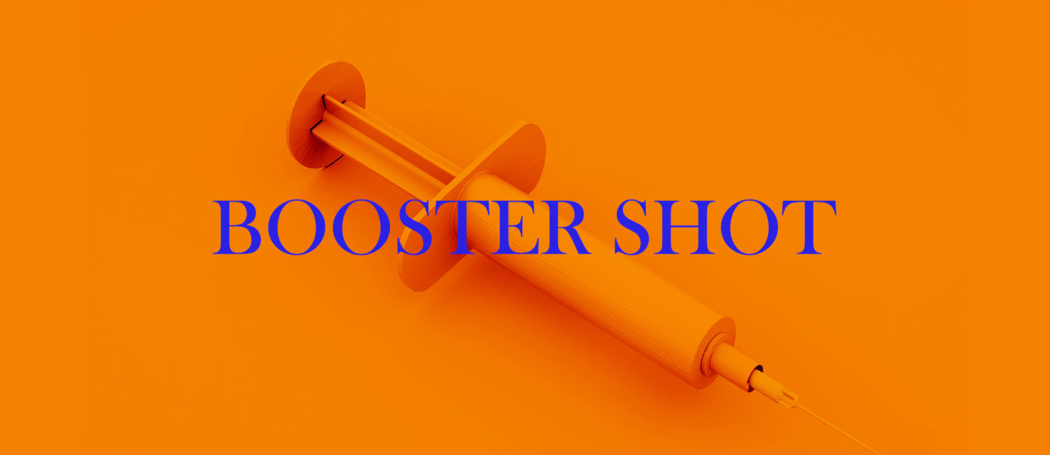 A syringe with the words Booster Shot