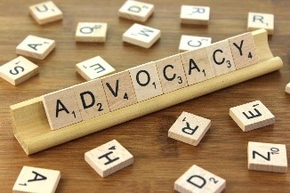 ADVOCACY spelled out in Scrabble game wood tiles