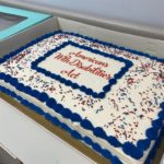 Large cake with white frosting and blue lettering that reads "Americans with Disabilities Act"