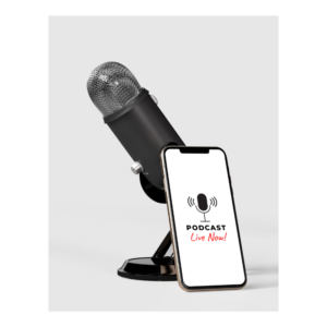 A black podcast microphone is on a desk. Leaning against the microphone is a cell phone, with the words "Podcast Live Now" on the screen.