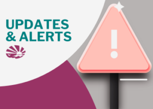 Large triangular warning sign with rounded corners, in soft coral with a white exclamation mark in the center. The sign is mounted on a black post. Text to the left reads "Updates & Alerts." Below the text is the ECI logo.