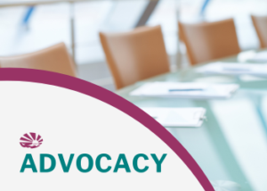 Background of conference room meeting table with chairs and papers. The word advocacy appears in the bottom left corner